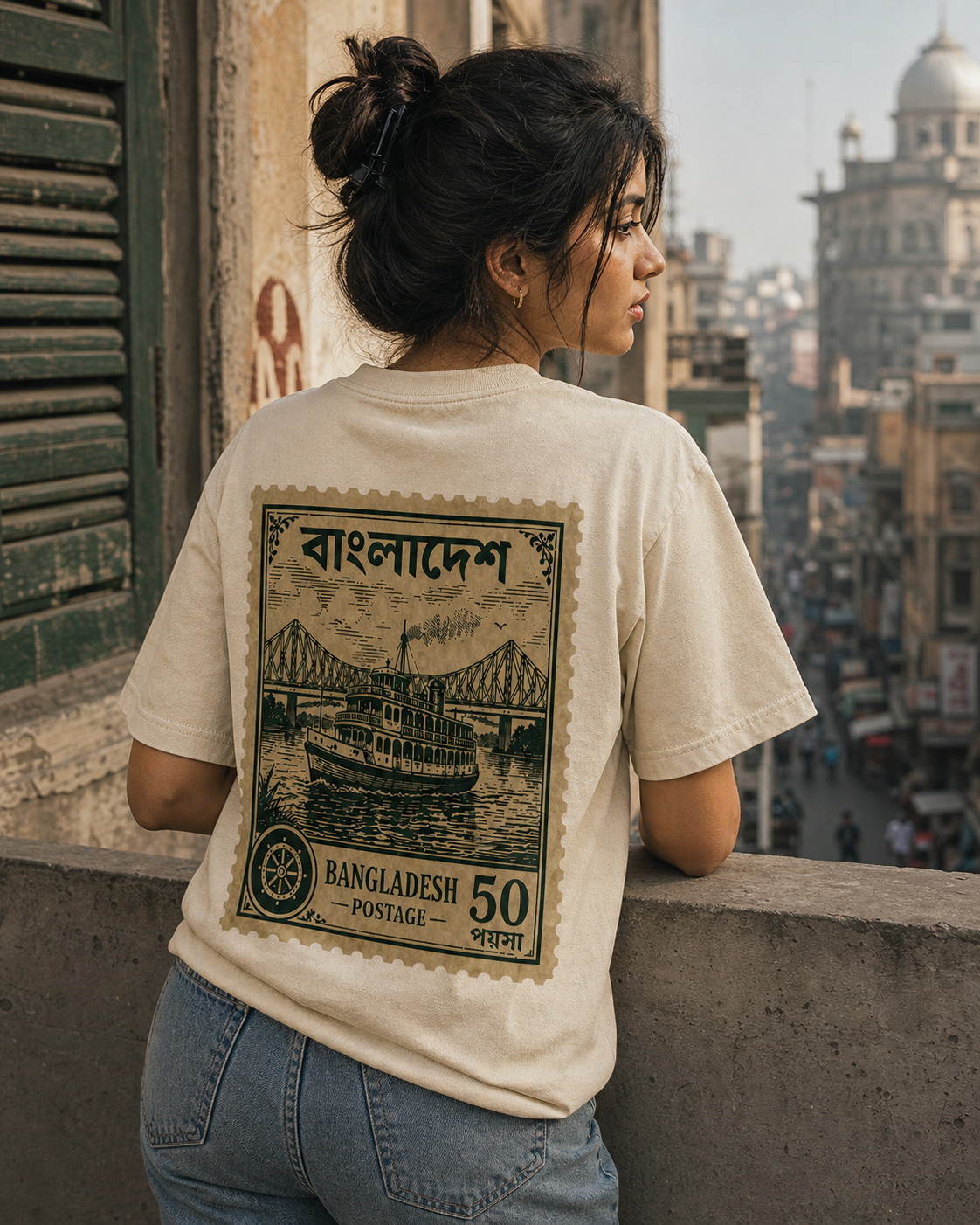 Person wearing a t-shirt with a graphic design of Bangladesh on a city street background