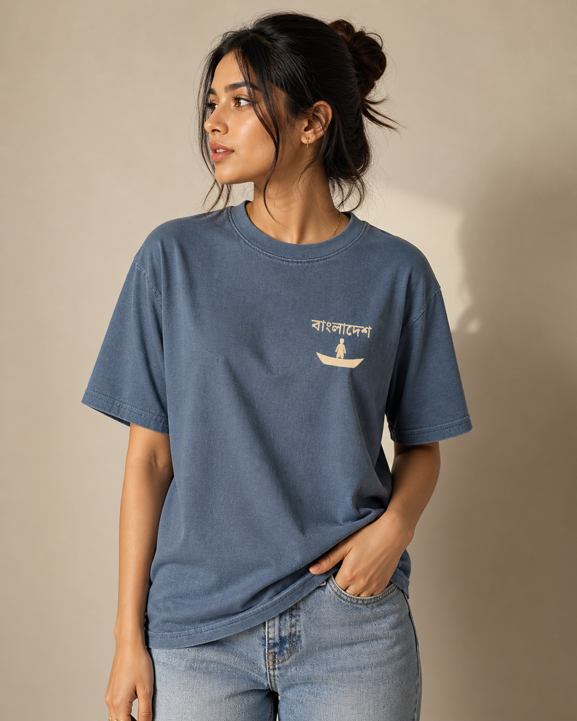 Woman wearing a blue t-shirt with a logo and text on a beige background